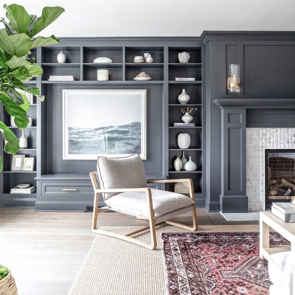How amazing is this charcoal gray living room built in with large art
