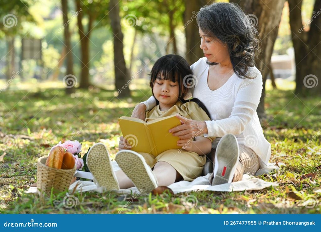Loving Grandmother Embracing Little Preschool Granddaughter and Reading