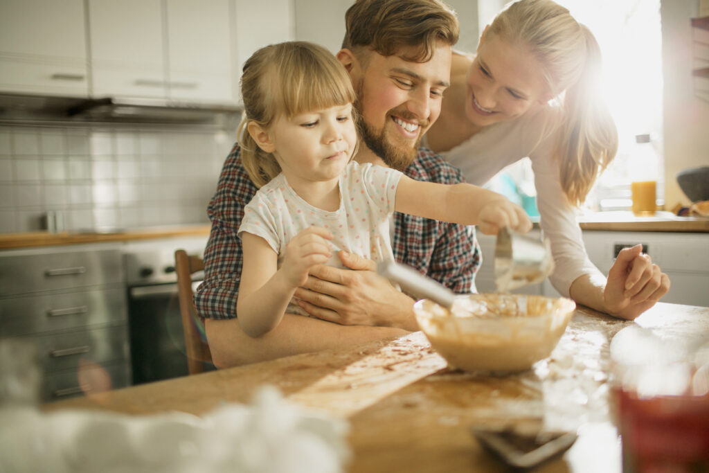 Young family baking together - Auburn Homes